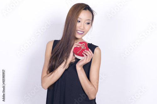 Lovely asian woman holding a gift box.