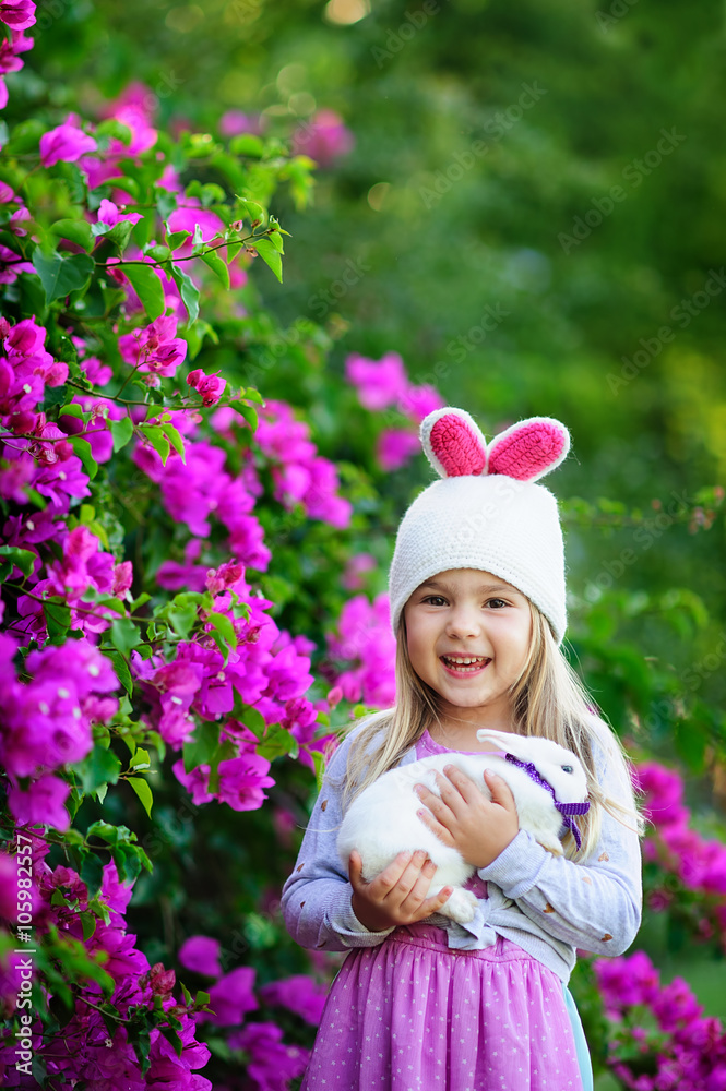 Cute happy girl with easter bunny