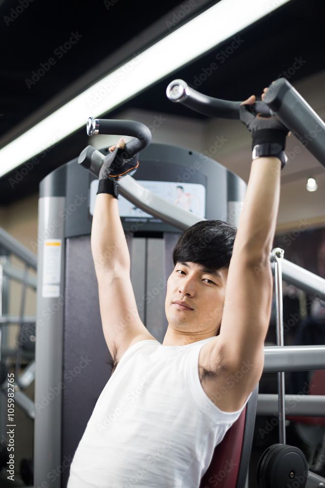 young handsome man works out in modern gym young handsome man works out in modern gym