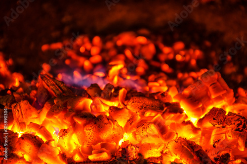 Heap of embers with a blue flame