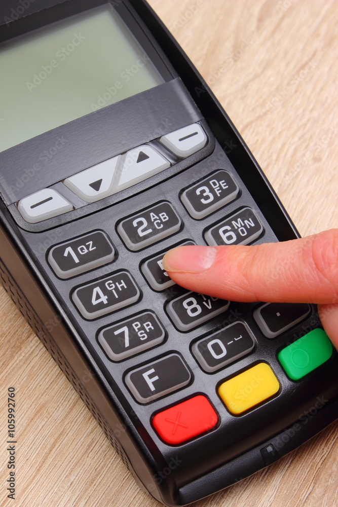 Hand of woman using payment terminal, enter personal identification number Hand of woman using payment terminal, enter personal identification number