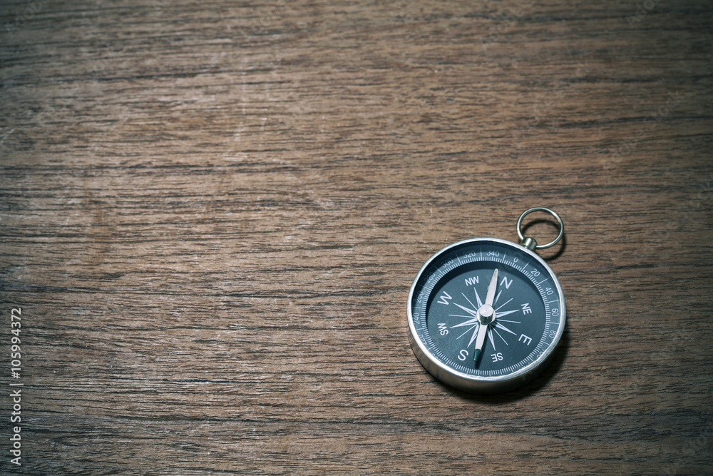 compass on old wood background with space for text,vintage tone. compass on old wood background with space for text,vintage tone.