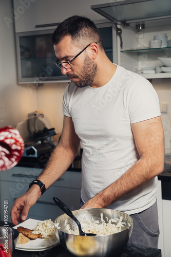 man making food in kitchen