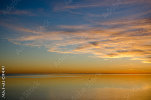 Colorful sunset by an absolutely calm water © olandsfokus