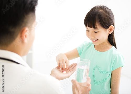 young doctor gives the child medicine