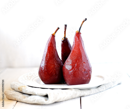 pears in red wine on a white background