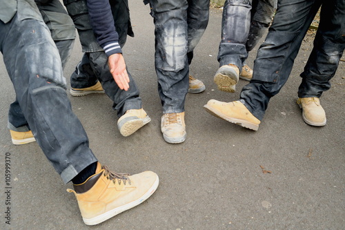 Group of real construction workers wearing safety shoes