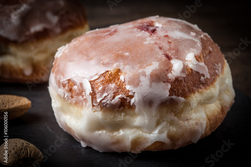 Donut with icing and rose jam.