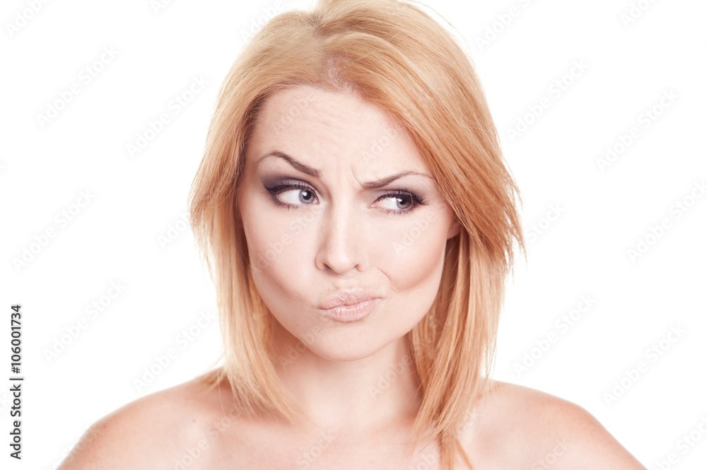 Emotional portrait of young girl frowning over white closeup Emotional portrait of young girl frowning over white closeup