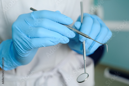 close-up of dentist hand with dental tools