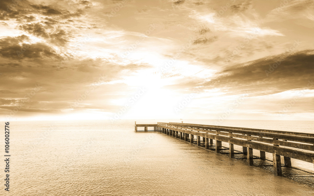 abstract background in sepia tone : long Exposure : sunset with long bridge ans smooth water surface