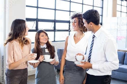 Businesspeople interacting in office during breaktime photo