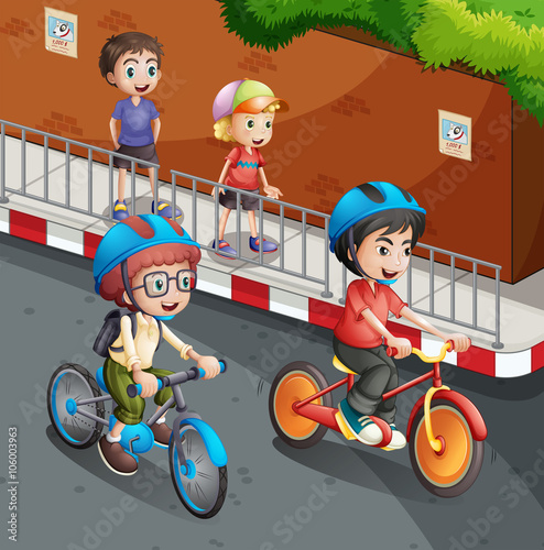 Children riding bicycle on the road with helmet on