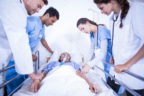 Doctors examining a patient on bed