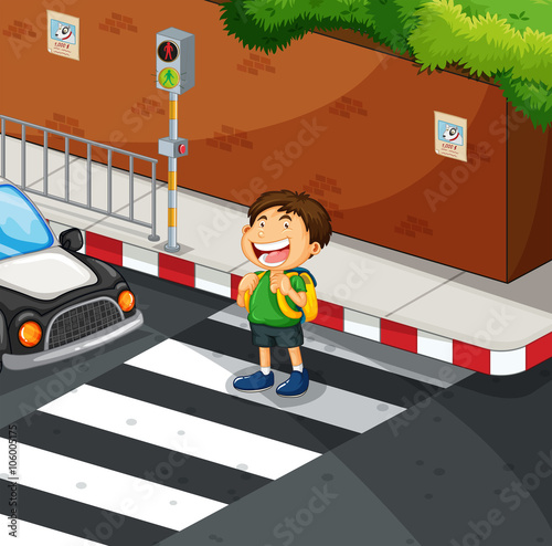 Boy crossing the road at zebra crossing