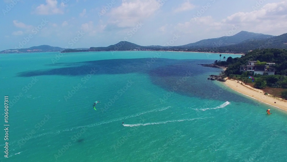 Aerial view of kitesurfing extreme sport with the wind freestyle. Beautiful top view of nice beach. Aerial view of kitesurfing extreme sport with the wind freestyle. Beautiful top view of nice beach.