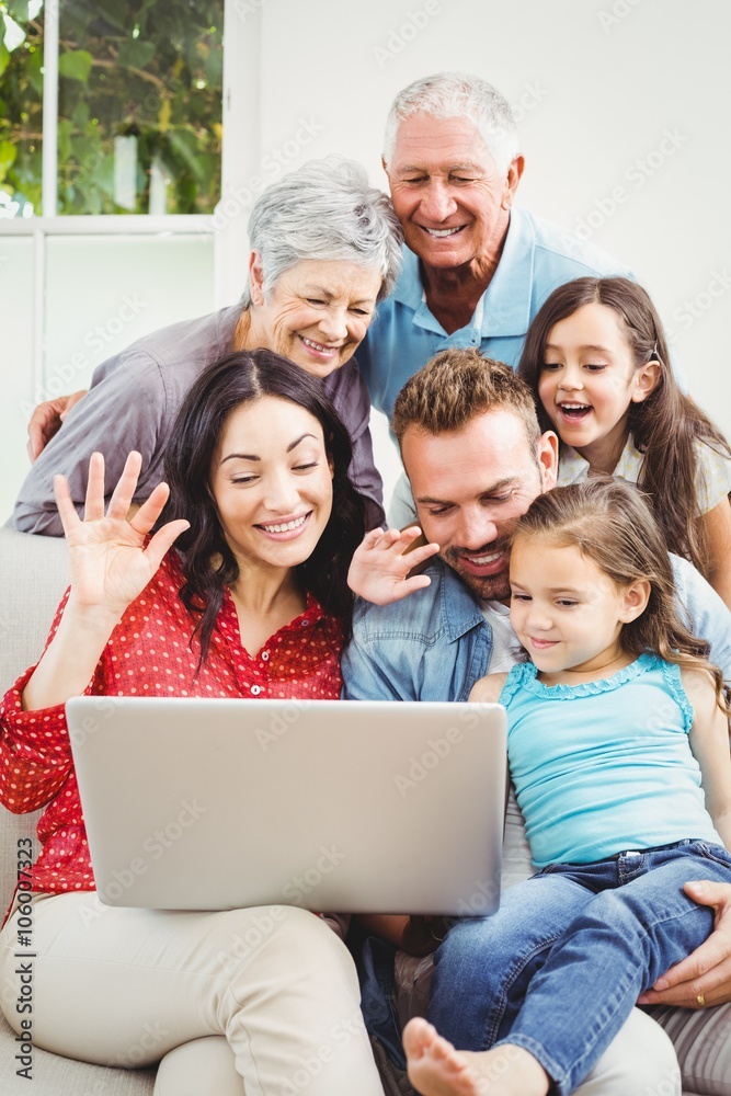 Happy multi generation family using laptop Happy multi generation family using laptop