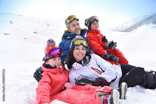 Portrait of family having fun laid in the snow