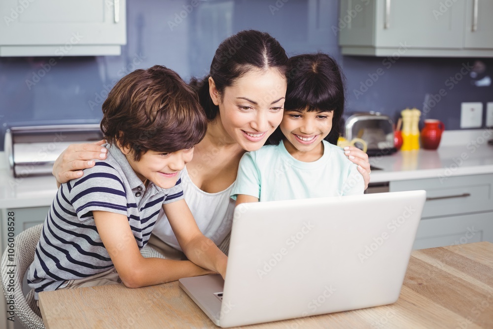 Happy mother and children working on laptop Happy mother and children working on laptop