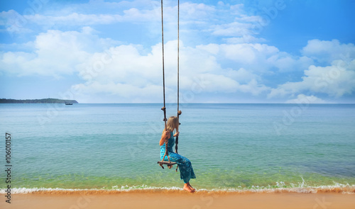 Woman relaxing on a swing on the beach , koh Samui, Suratthani, Thailand