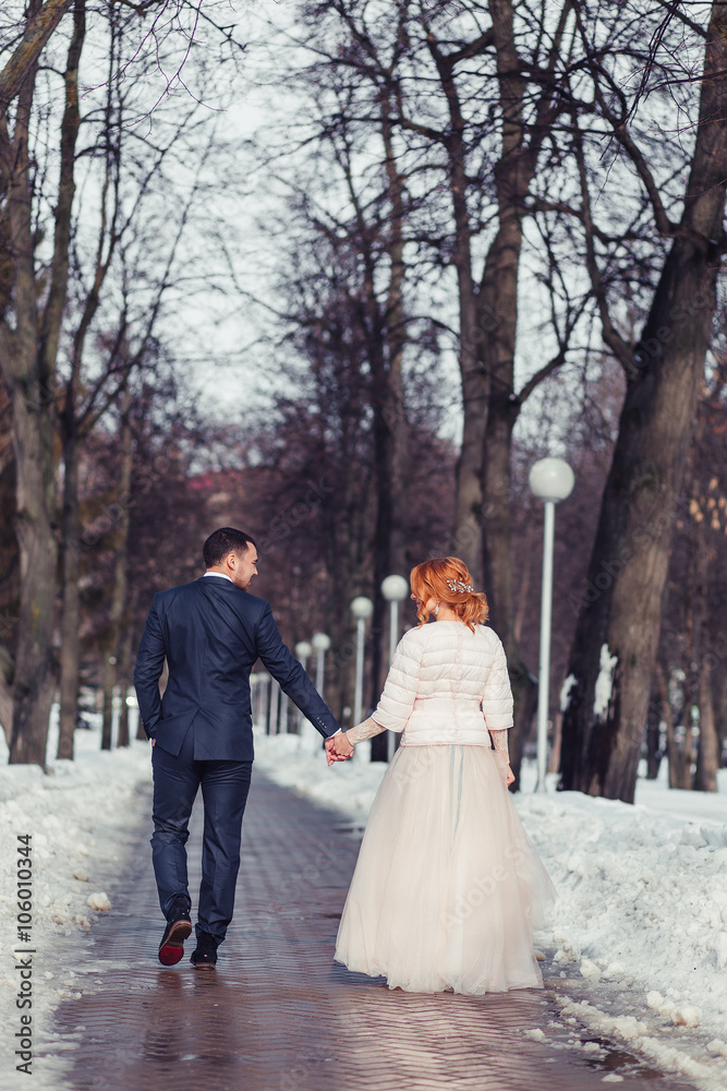 gorgeous elegant luxury bride and stylish groom hugging and walk