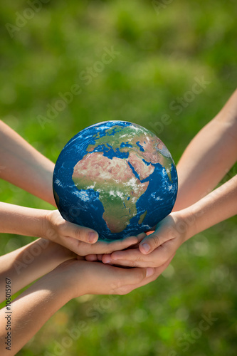 Fototapeta Naklejka Na Ścianę i Meble -  Children holding Earth planet in hands
