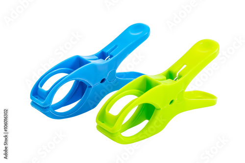 Two plastic spring clamps isolated over white background photo