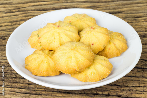 Cookies in a dish on the wooden teble photo