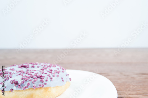 donut   delicious and unhealthy donut lying on a table ready to eat