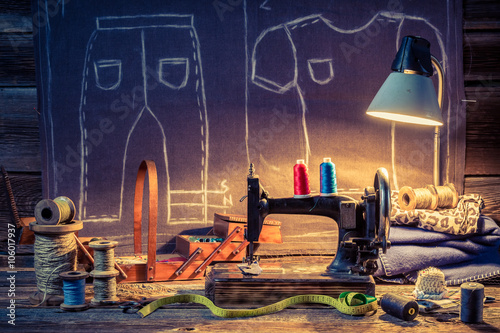 Old tailor workshop with sewing machine and cloth
