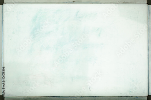 фотографія Old whiteboard for office with traces of stains and spots