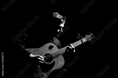 Photography Male musician playing on acoustic guitar. Black and white photo.