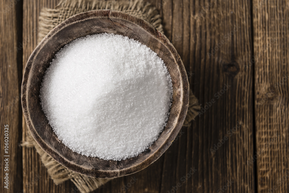 White Sugar (selective focus) on wooden background White Sugar (selective focus) on wooden background
