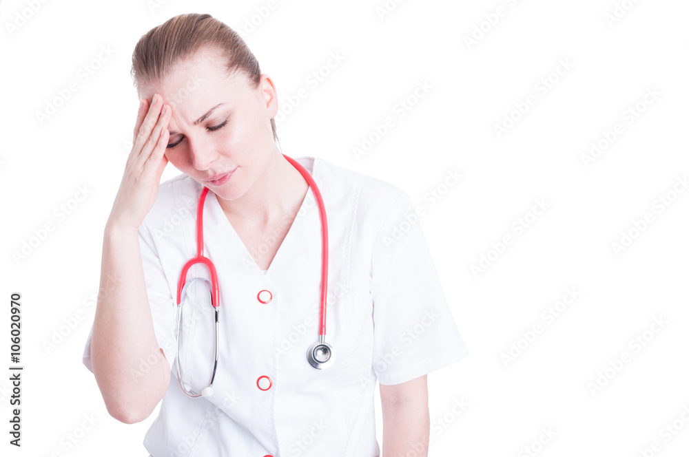 Stressed female doctor being tired and suffer from headache