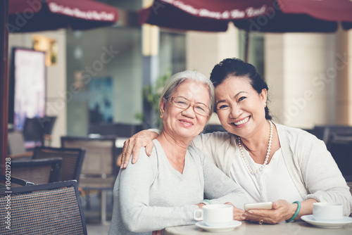 Portrait of two hugging smiling senior women