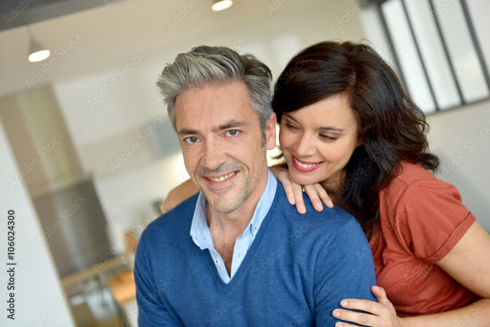 Portrait of middle-aged couple enjoying new home Portrait of middle-aged couple enjoying new home