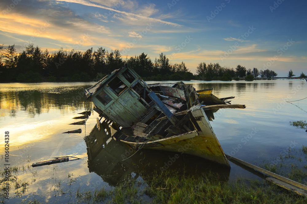 Old abandoned fisherman boat on the riverside