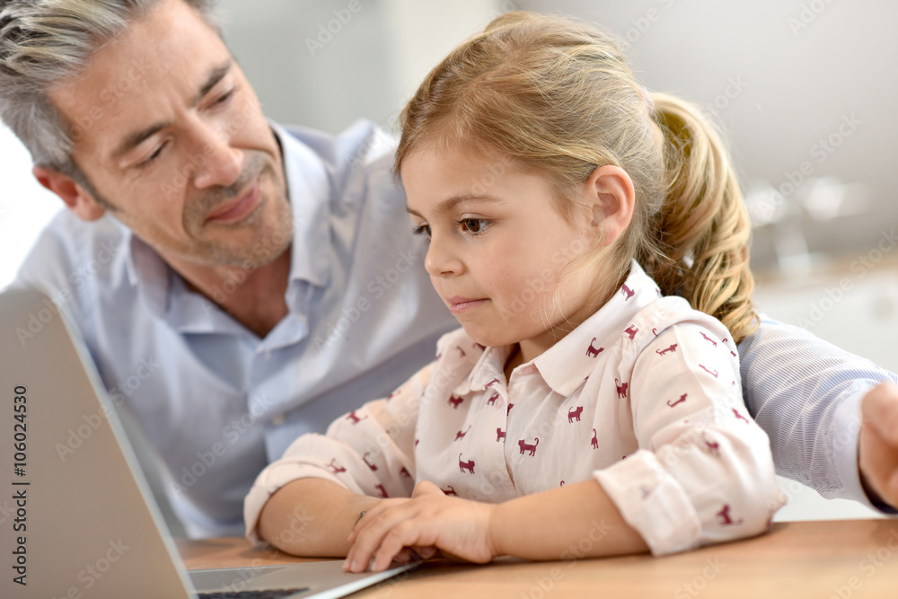 Man with little girl using laptop computer Man with little girl using laptop computer