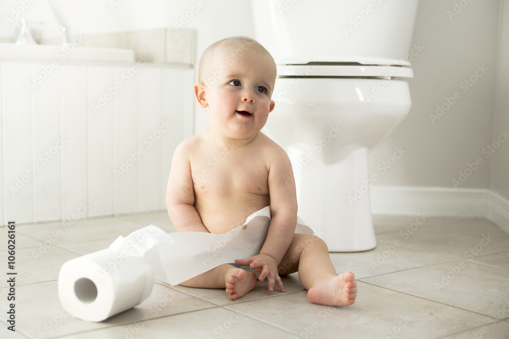 Adorable baby boy playing with toilet paper Adorable baby boy playing with toilet paper