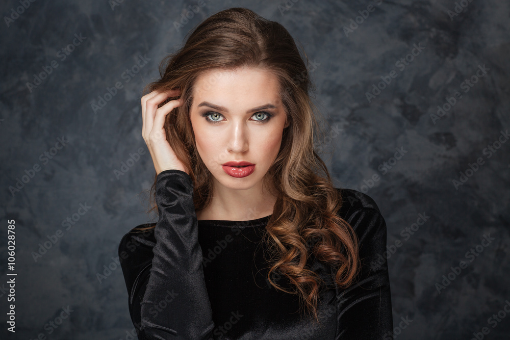Sensual young woman touching her hair by hand Sensual young woman touching her hair by hand