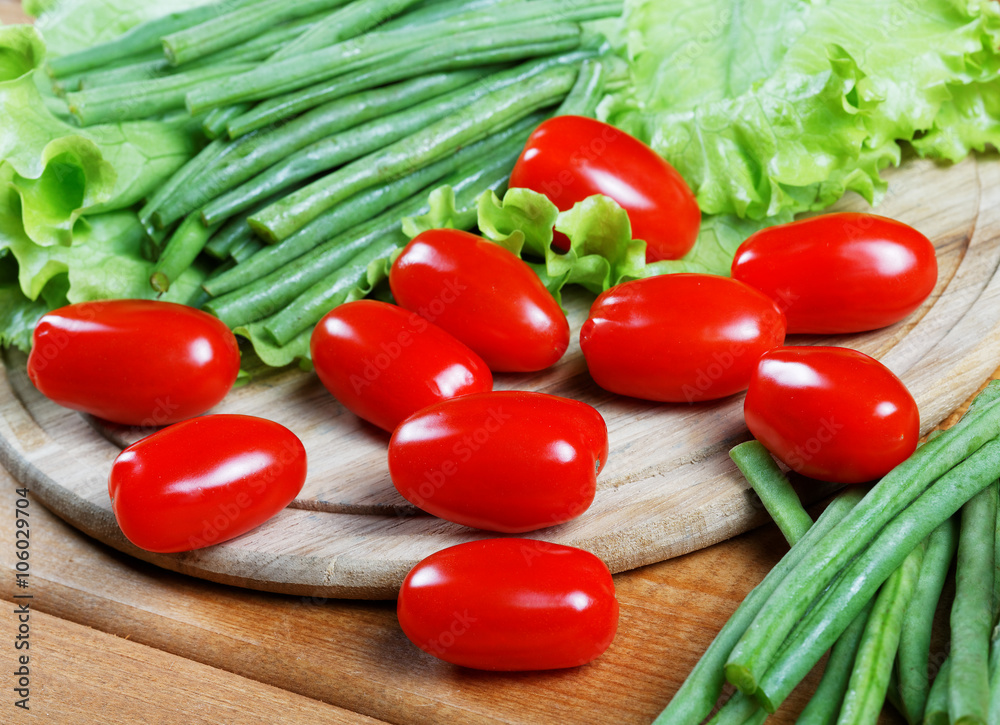 Small tomatoes and salad leaves close up Small tomatoes and salad leaves close up