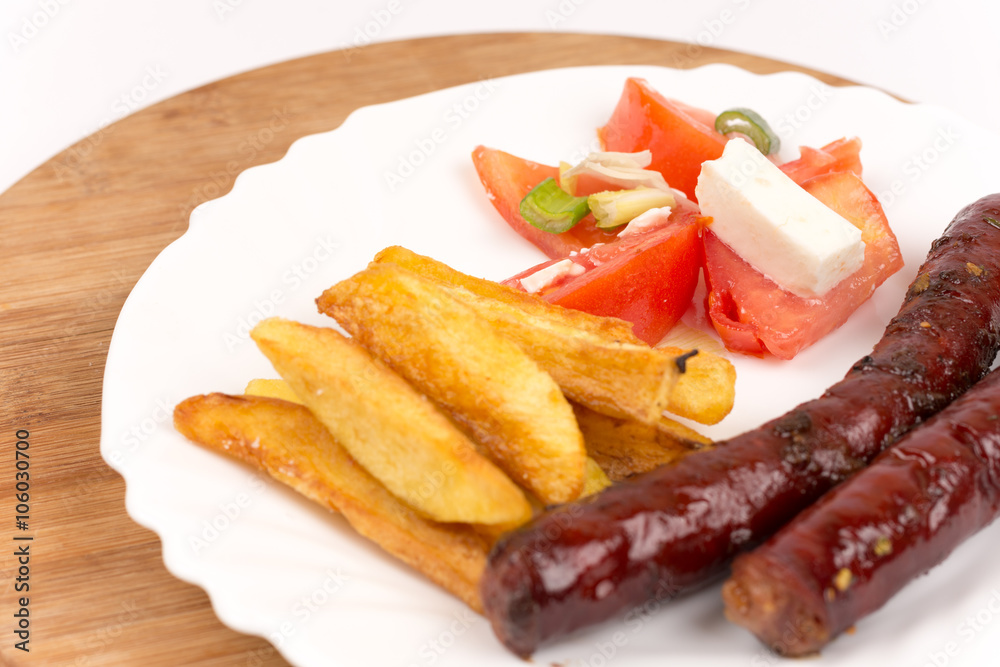Grilled homemade red sausages with potatoes and tomatoes Grilled homemade red sausages with potatoes and tomatoes