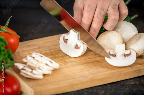 Male hands cutting vegetables for salad