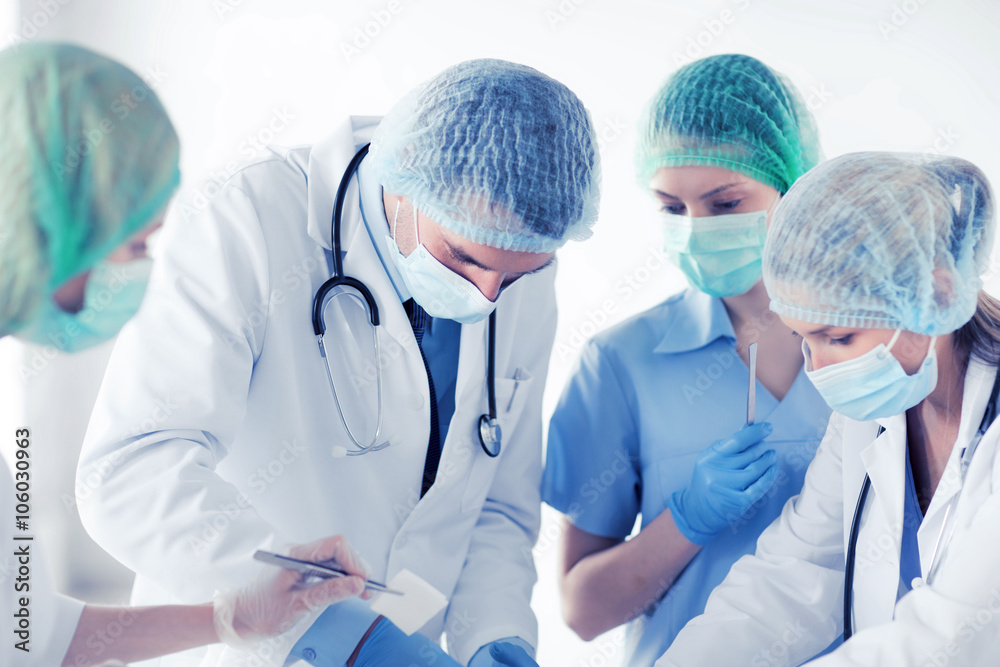 young group of doctors doing operation young group of doctors doing operation