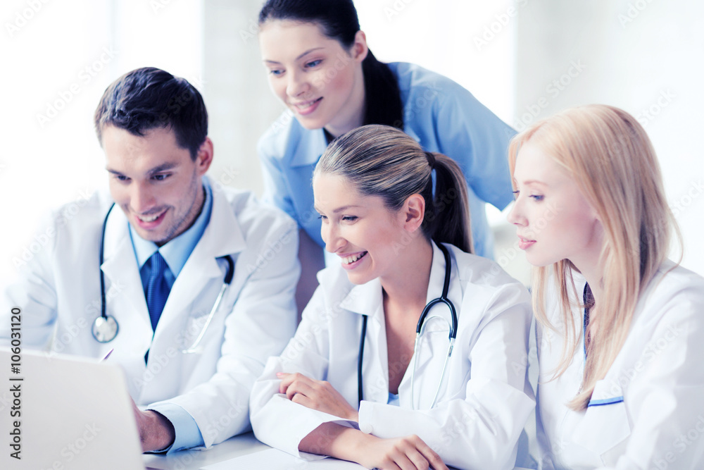group of doctors looking at tablet pc