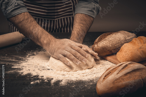 Fototapeta Naklejka Na Ścianę i Meble -  Male hands knead the dough.
