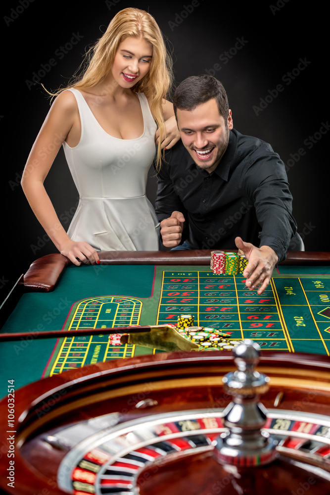 Couple playing roulette wins at the casino. Couple playing roulette wins at the casino.