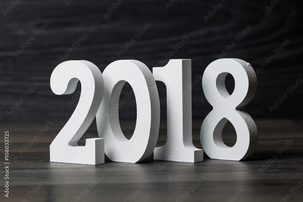 White word of 2018 on black wooden background. White word of 2018 on black wooden background.