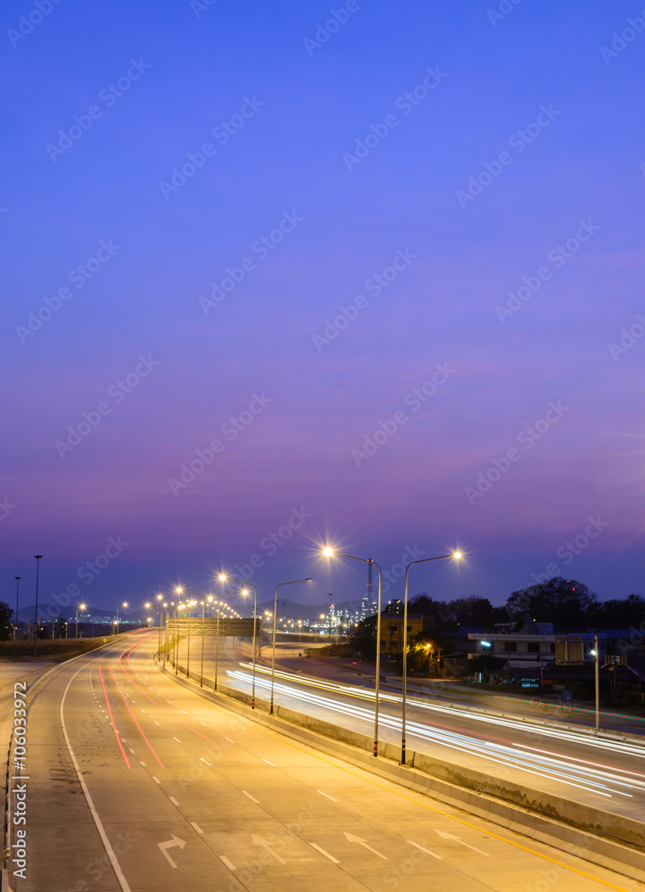 Car light trails on motorway with beautiful skyscape at twilight