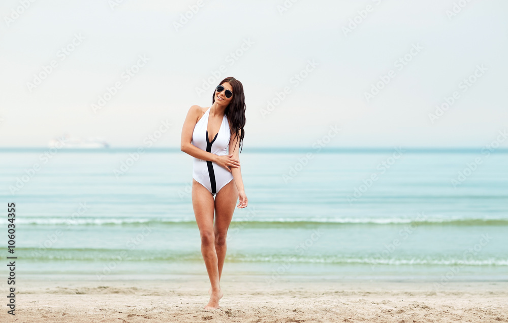 young woman in swimsuit posing on beach young woman in swimsuit posing on beach